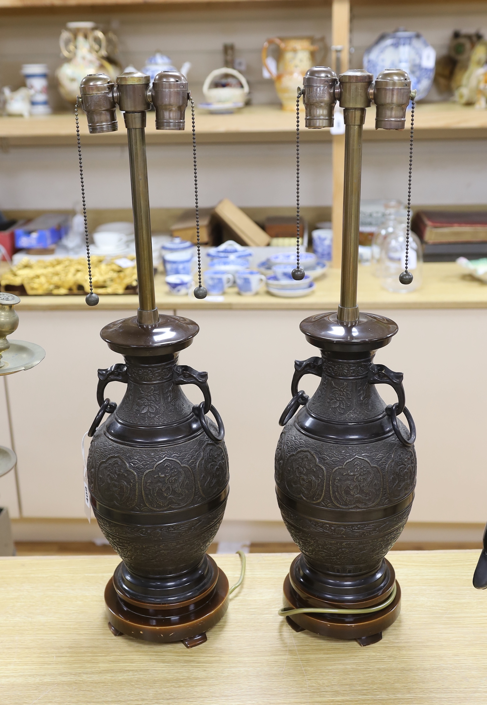 A pair of Japanese archaistic bronze vases mounted as table lamps, 70cm total height